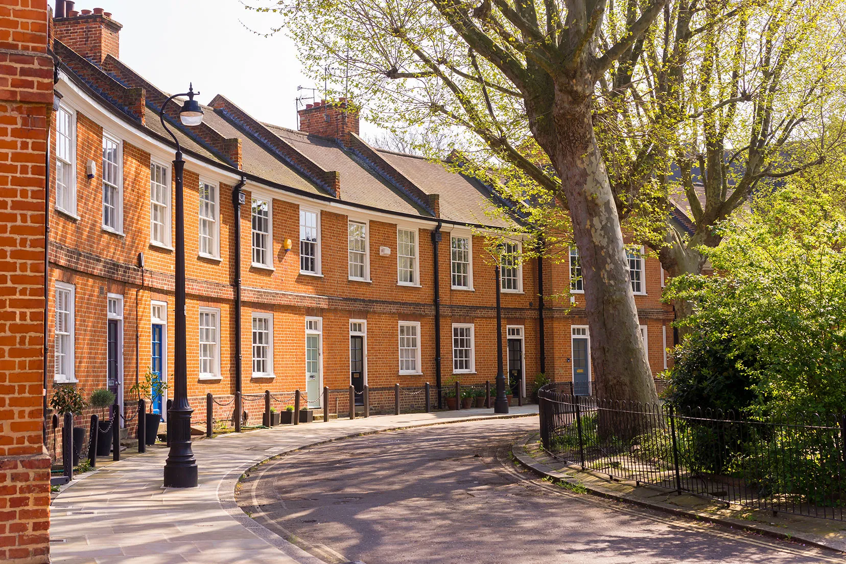 A brick building with a tree in front of it.